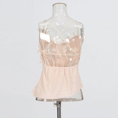 Mannequin wearing a light pink dress with sheer straps on a white background
