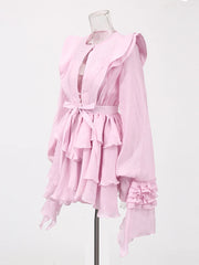 Pink dress with ruffled layers on a mannequin against a white background