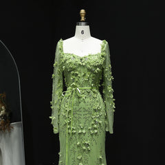 Green floral dress on a mannequin against a black background