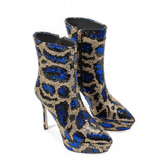 Blue and gold patterned high-heeled boots on a white background