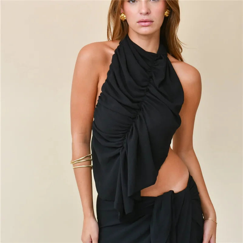 Black halter neck dress with cut-out design on a beige background