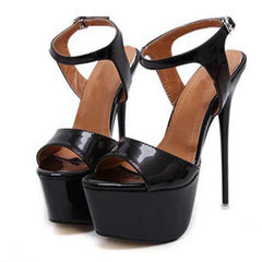Black high-heeled platform sandals on a white background
