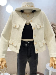 Mannequin wearing a cream-colored jacket with gold buttons, black pants, and a beige hat.
