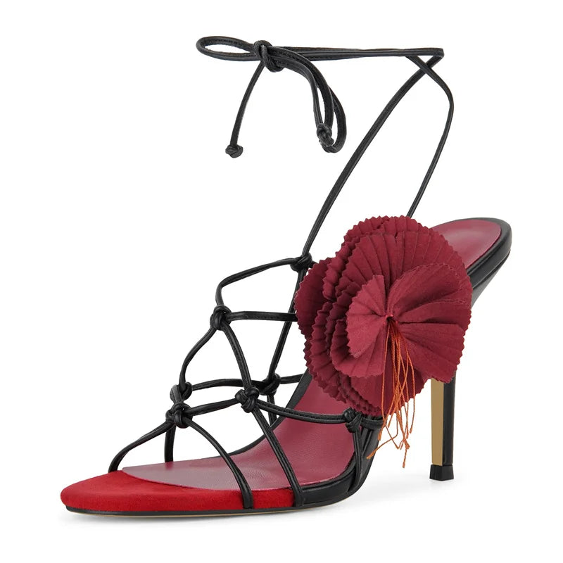 Stiletto lace-up sandals with floral accent and red toe