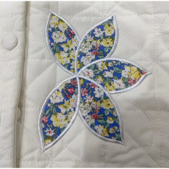 Floral leaf patch on a quilted fabric background