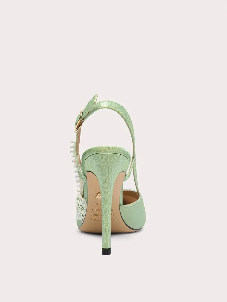 Mint green high-heeled shoe with a strap on a white background
