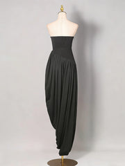 Black strapless dress on a mannequin against a plain background
