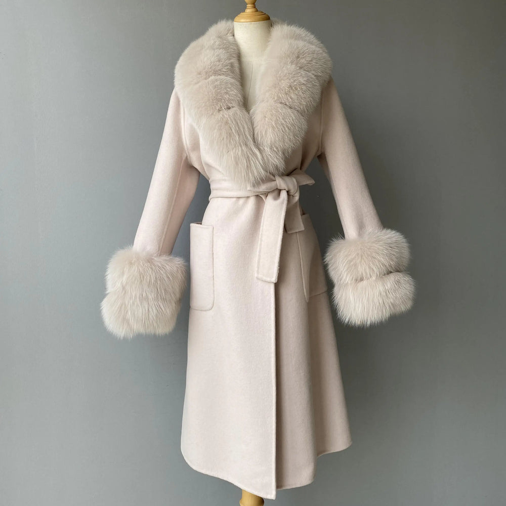 Beige coat with fur trim on a mannequin against a gray background