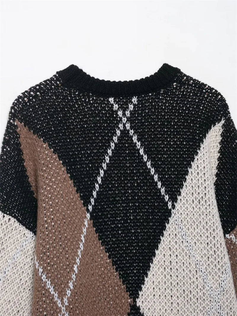 Close-up of a patterned sweater with black, white, and brown colors on a white background.