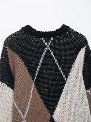Close-up of a patterned sweater with black, white, and brown colors on a white background.