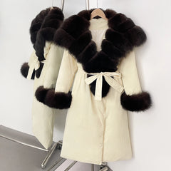 Cream-colored coat with dark fur trim on a white background