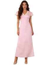 Woman wearing a pink polka dot dress on a white background