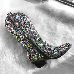 Decorative shoe with colorful gemstones on a white fur background
