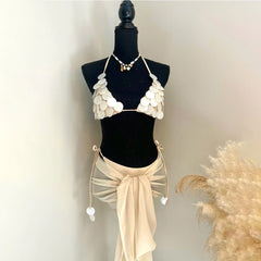 Off-white shell-embellished bikini top with a matching sheer wrap skirt.