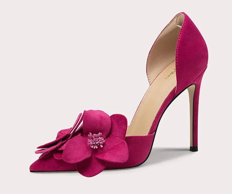 Pink high-heeled shoe with a flower design on a light gray background