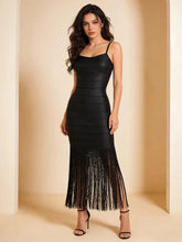 Black faux leather stripe maxi dress with fringe hem, spaghetti straps.