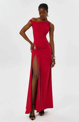 Model posing in a red one-shoulder maxi dress with a side slit