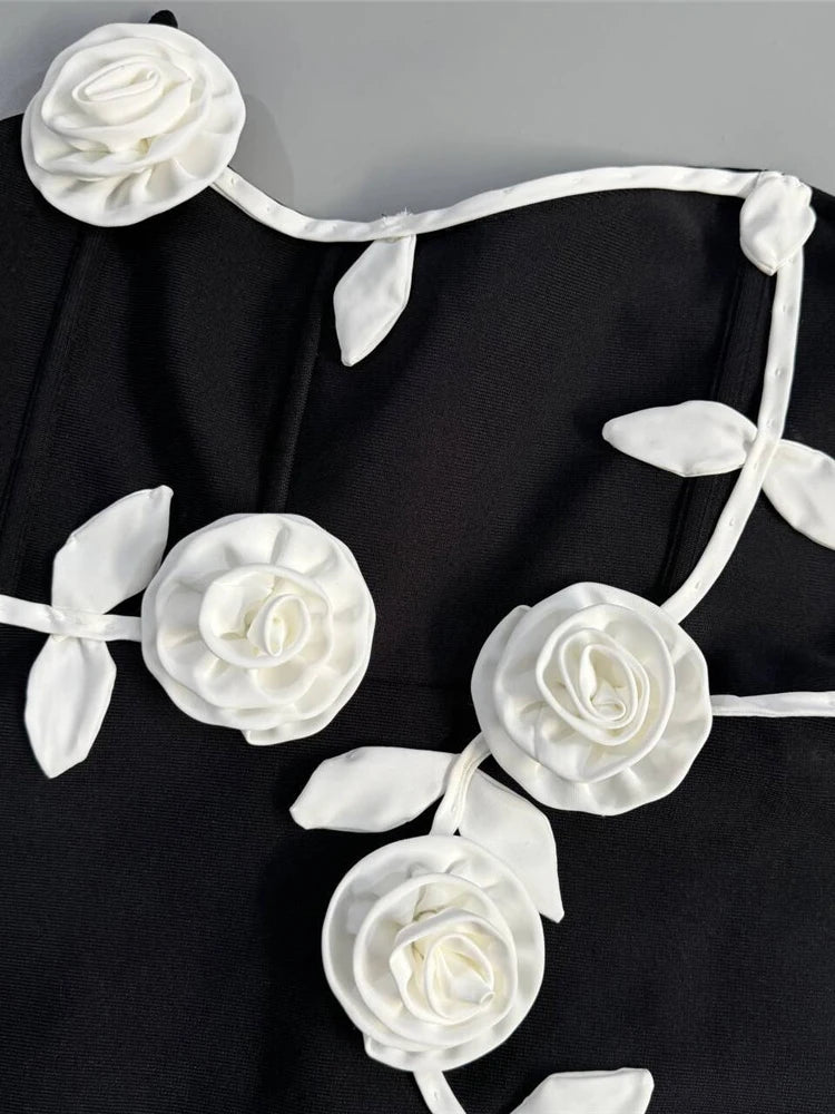 Necklace with white floral design on a black fabric background