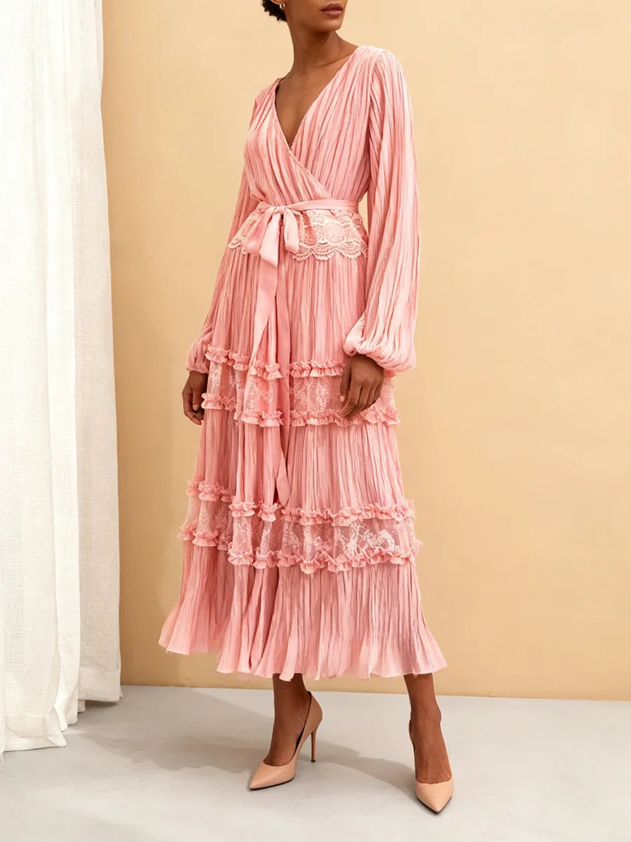 Pink dress with ruffled layers on a neutral background