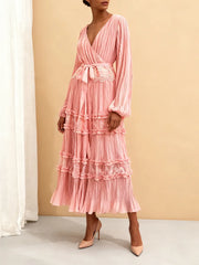 Pink dress with ruffled layers on a neutral background