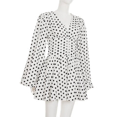 White dress with black polka dots on a mannequin against a white background