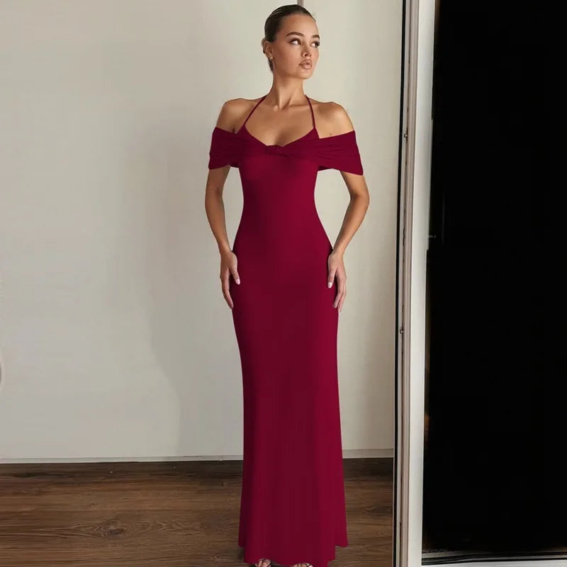Woman wearing a burgundy off-shoulder dress against a neutral background