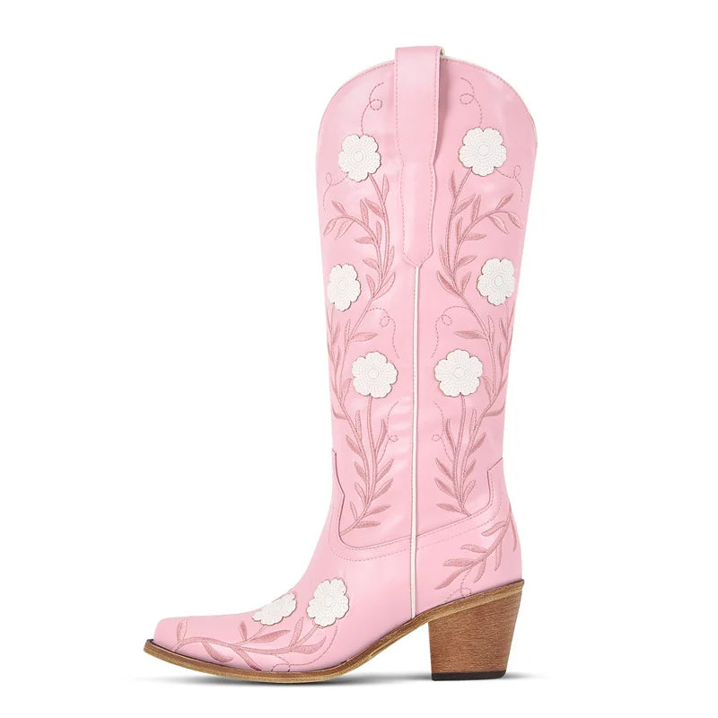 Pink cowboy boot with white floral designs on a white background