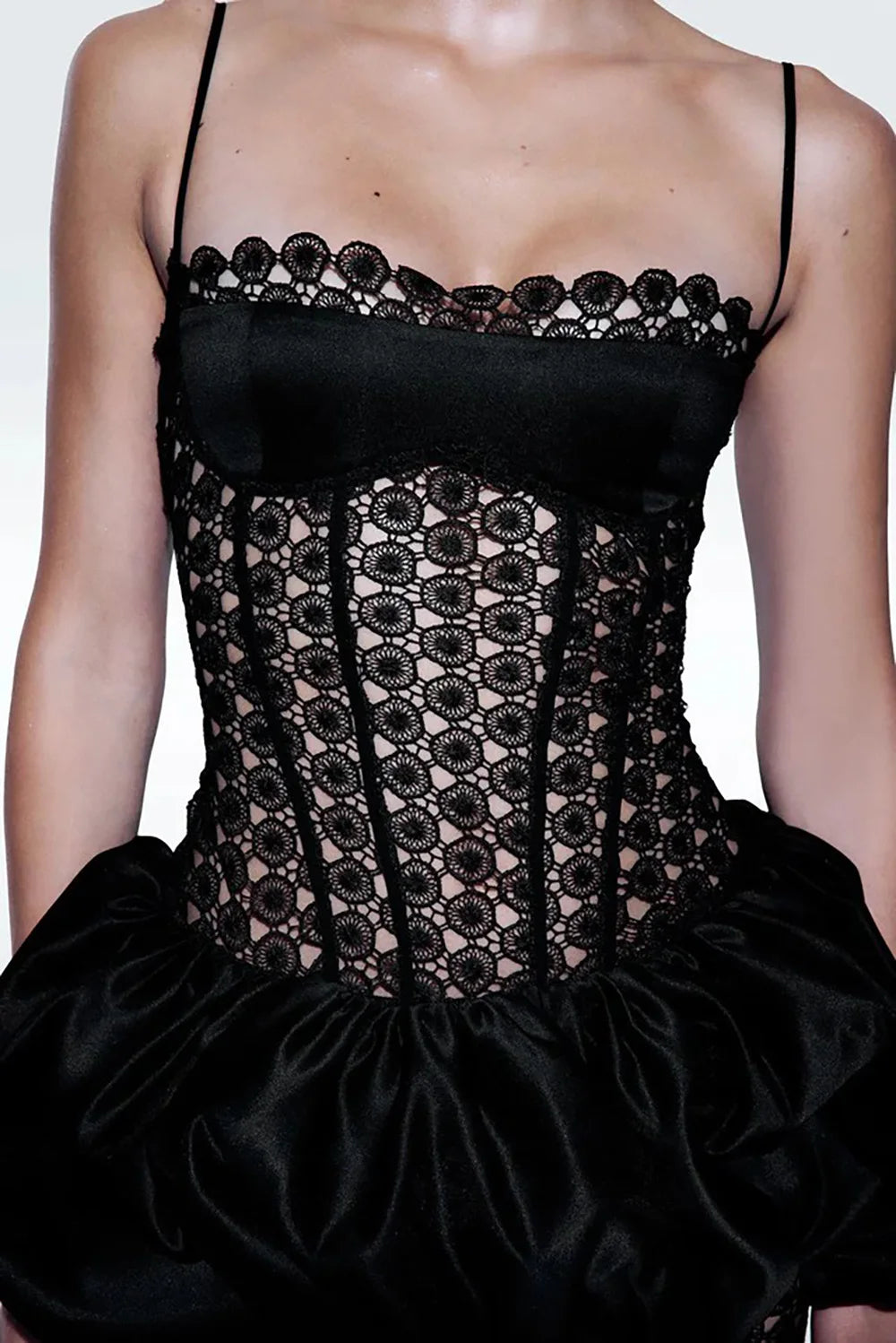 Detail of puffed satin skirt on a geometric lace midi dress