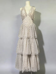 Polka dot dress on a mannequin against a gray background