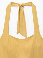 Yellow apron with a tied neck strap on a white background