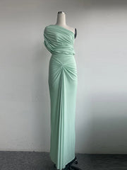 Mint green one-shoulder evening gown on a mannequin against a plain background
