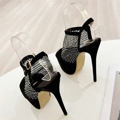 Black high-heeled shoes with clear mesh design on a white background