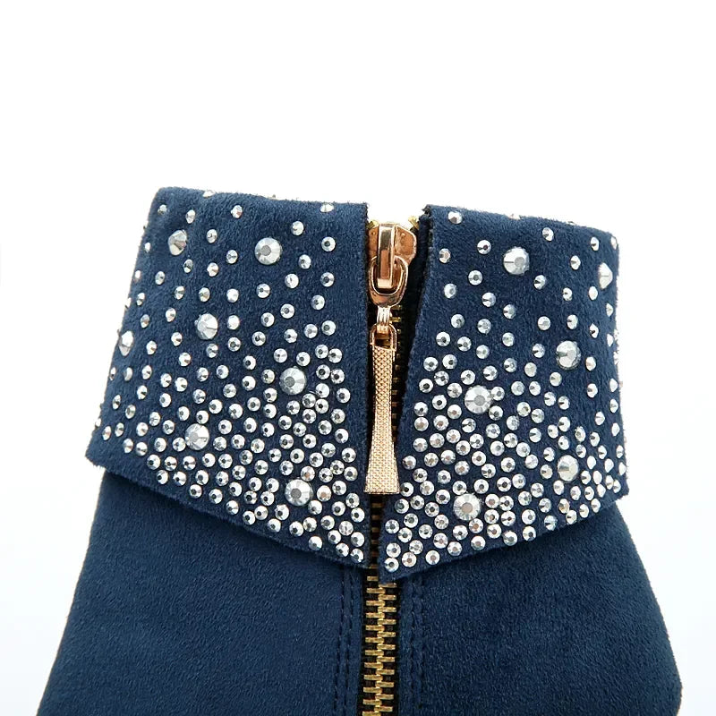 Navy blue clutch bag with gold zipper and silver embellishments on a white background