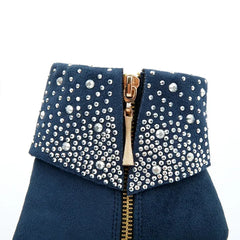 Navy blue clutch bag with gold zipper and silver embellishments on a white background