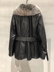 Black leather jacket with fur hood on a neutral background