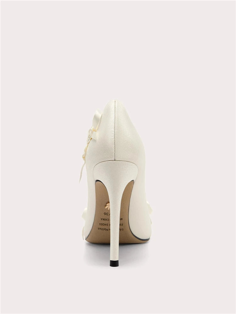 White high-heeled shoe on a light gray background