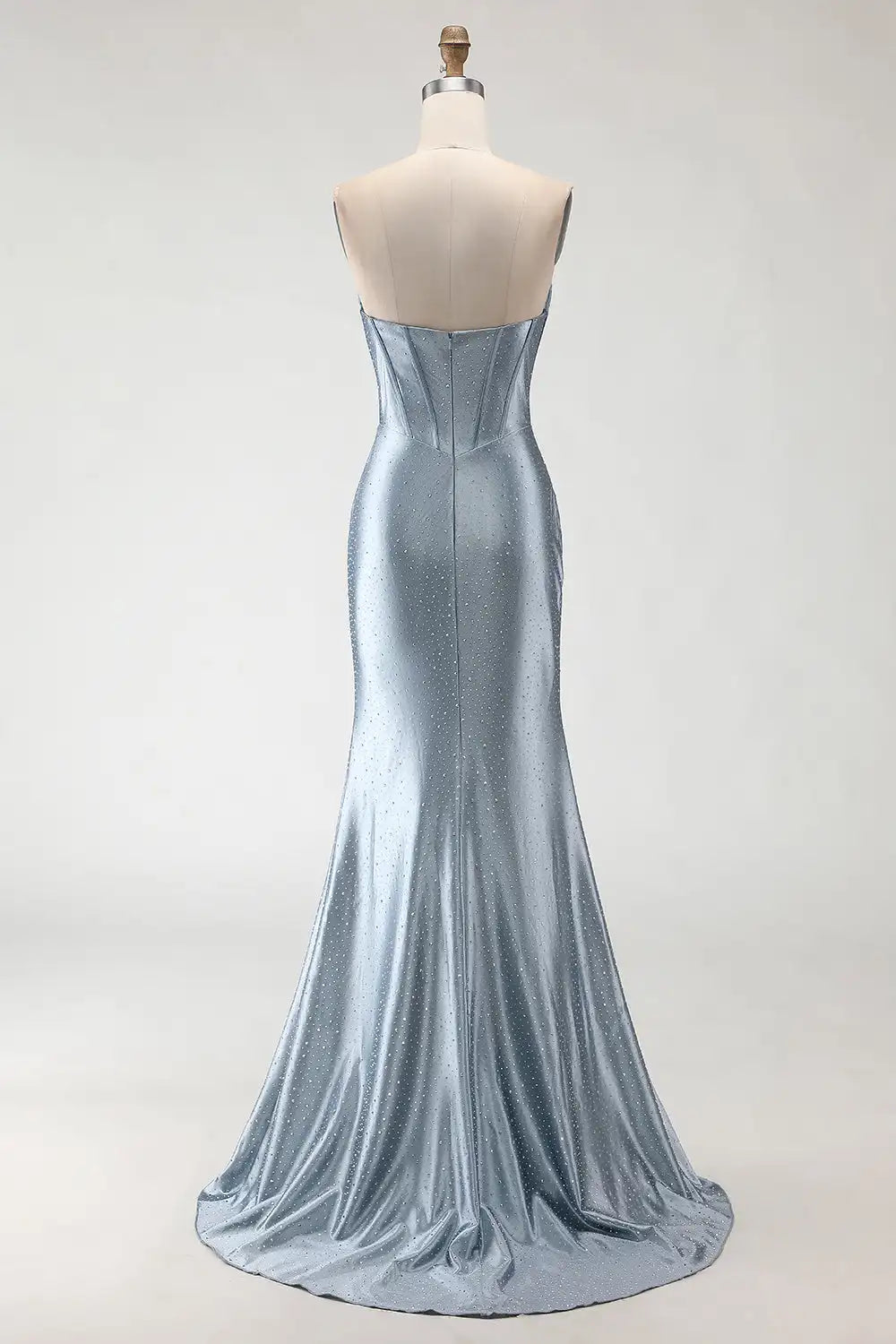 Silver evening gown on a mannequin against a white background