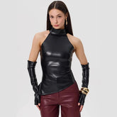 Woman wearing a black leather top and maroon pants with long gloves on a white background