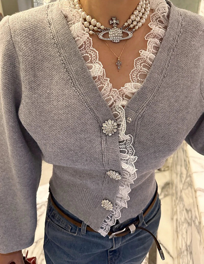 Gray cardigan with lace details and a necklace worn by a person.