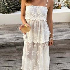 Model holding a drink in a sheer mesh midi dress with floral lace
