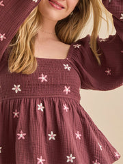 Close-up of floral embroidery on square neck peplum top