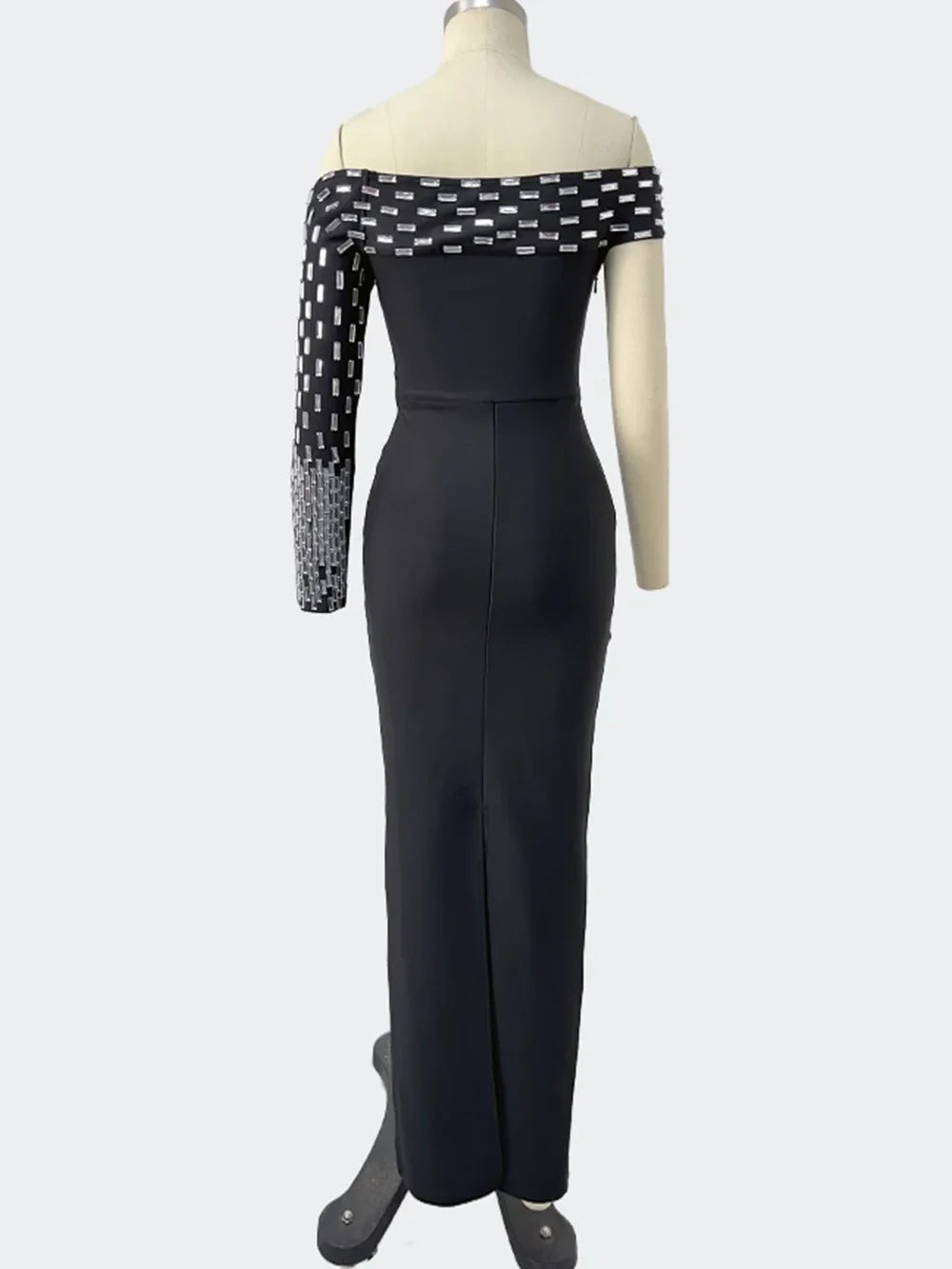 Black off-shoulder dress with geometric pattern on a mannequin against a white background