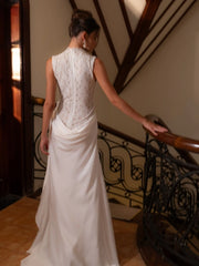 Woman in a white wedding dress standing on a staircase