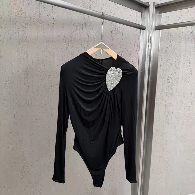 Black asymmetrical long-sleeve bodysuit with heart rhinestone on hanger