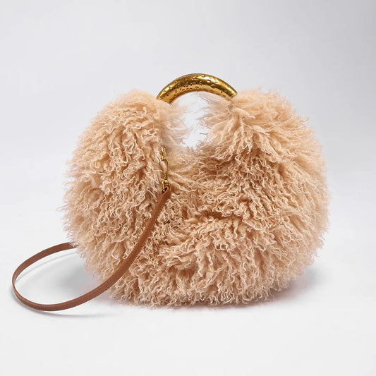 Curly faux fur round bag in beige with a gold metallic handle and a thin leather strap.