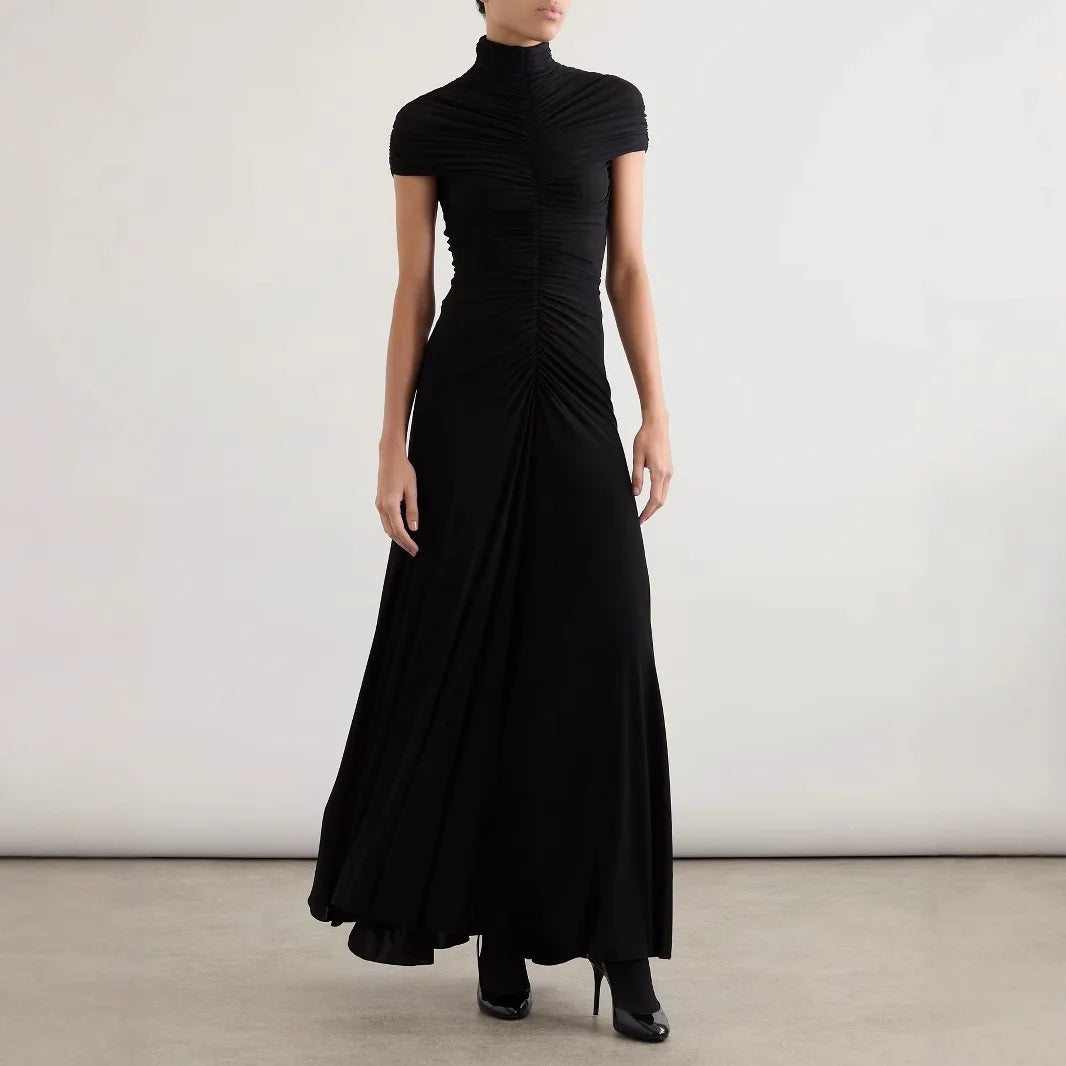 Black dress worn by a person on a plain background