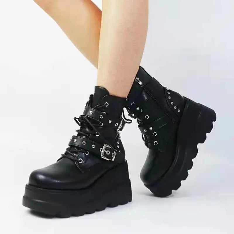 Black platform boots with detailed laces on a white background