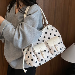 White polka dot faux leather tote bag with dual front pockets