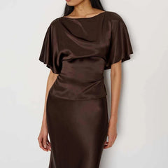 Brown satin blouse with cape-like sleeves on a white background