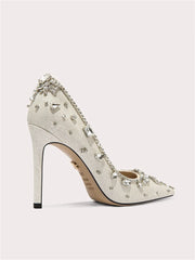 Sparkly high-heeled shoe with crystal embellishments on a light gray background